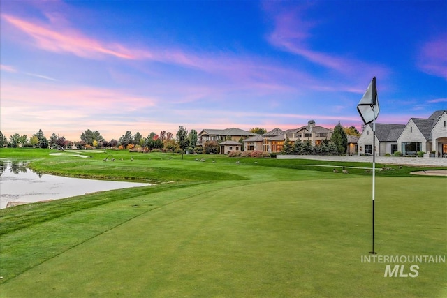 6964 N Moon Drummer Way, Meridian, ID 83646 - view of property's community with a water view, view of golf course, a yard, a putting green, and a residential view