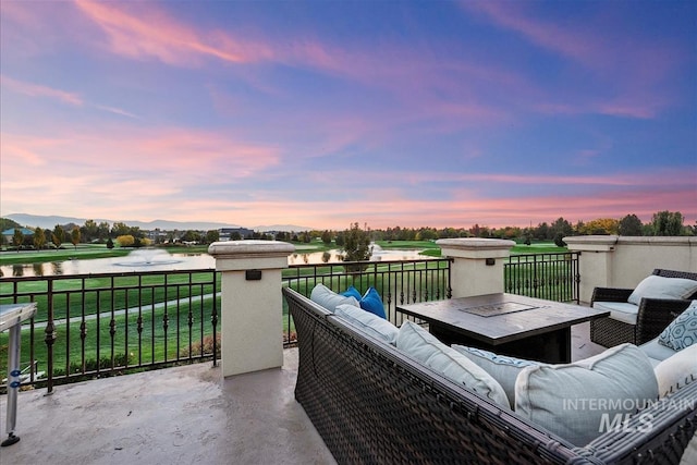6964 N Moon Drummer Way, Meridian, ID 83646 - patio terrace at dusk featuring an outdoor living space and a water view