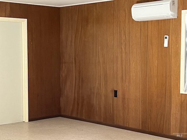 spare room with a wall mounted AC and wooden walls