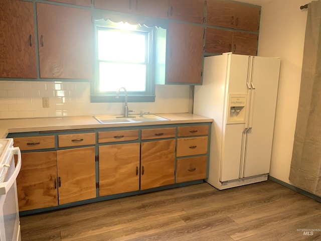 428 Orchard Dr, Gooding, ID 83330 - kitchen featuring a sink, white refrigerator with ice dispenser, range, wood finished floors, and light countertops