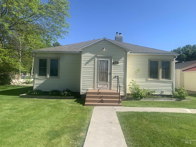 428 Orchard Dr, Gooding, ID 83330 - bungalow-style home featuring a chimney, a front lawn, and roof with shingles