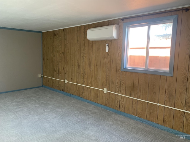 unfurnished room with baseboards, a wall unit AC, carpet flooring, and wood walls