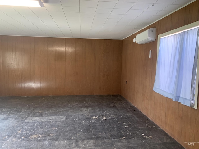 spare room featuring wooden walls and a wall mounted AC