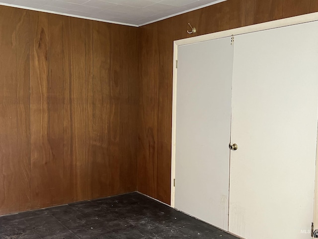 spare room featuring wood walls