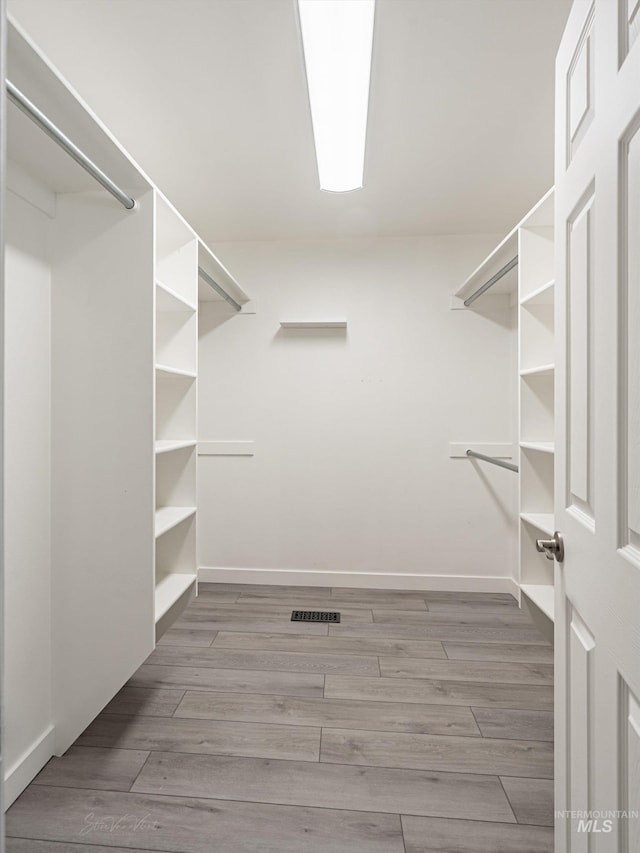 spacious closet featuring light wood-type flooring