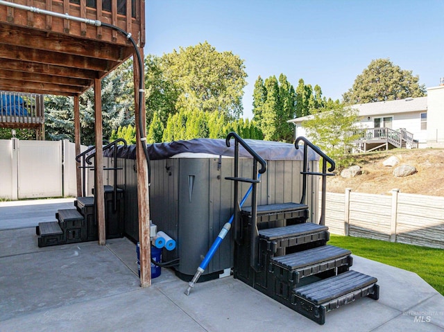 view of patio / terrace with a hot tub