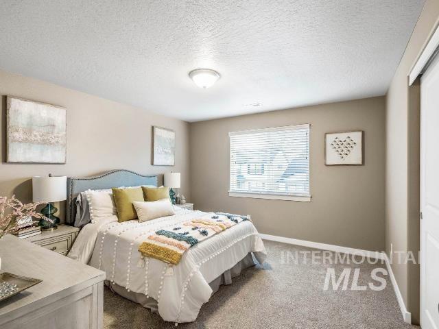 carpeted bedroom with a textured ceiling