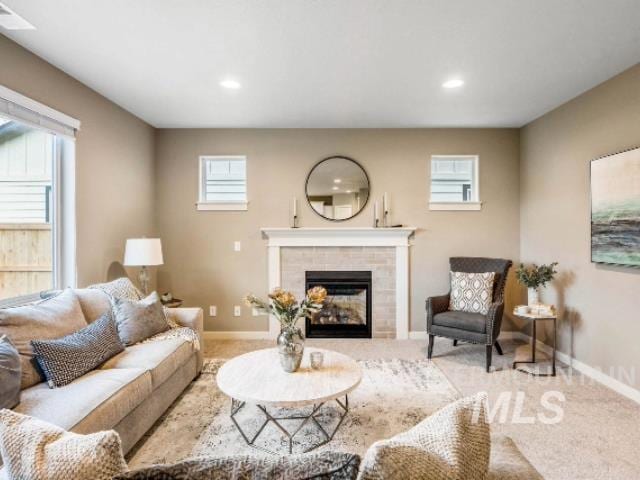 carpeted living room featuring a fireplace and a wealth of natural light