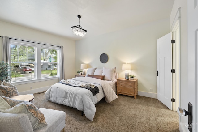 bedroom with baseboards and light carpet