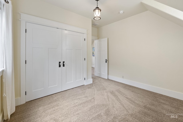 unfurnished bedroom featuring carpet floors, baseboards, a closet, and visible vents