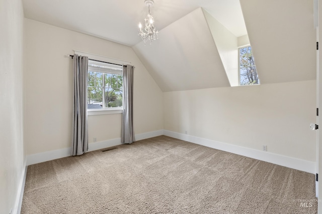 additional living space with baseboards, plenty of natural light, carpet, and lofted ceiling