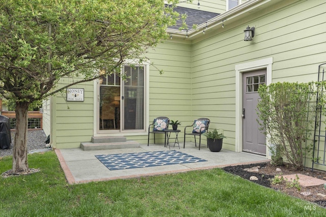 exterior space with a patio, a shingled roof, and entry steps