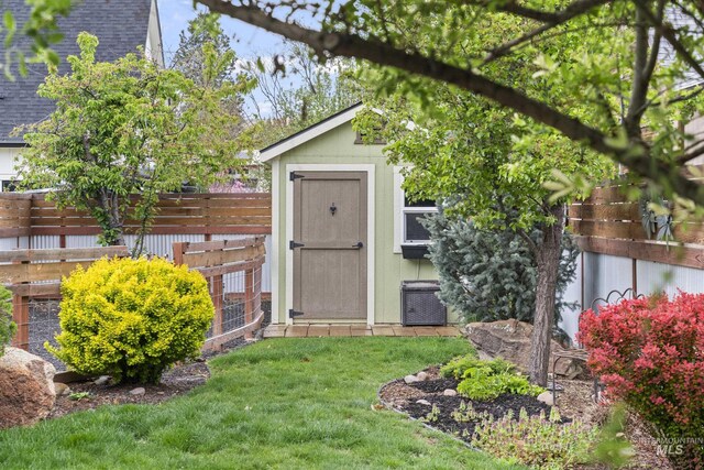 view of shed with a fenced backyard and central AC unit