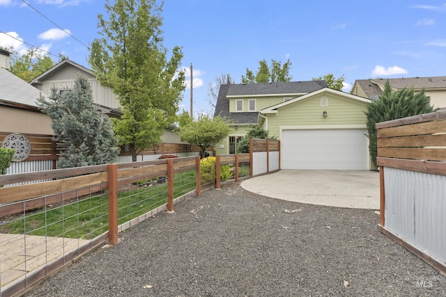 exterior space featuring a garage, aphalt driveway, and fence