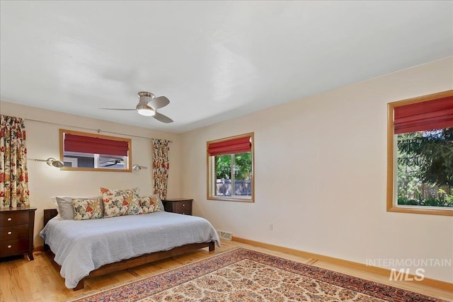 424 N Mobley Dr, Boise, ID 83712 - bedroom with light wood-style floors, ceiling fan, and baseboards