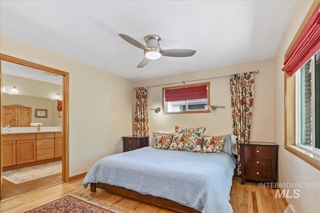 424 N Mobley Dr, Boise, ID 83712 - bedroom with multiple windows, light wood-style floors, connected bathroom, and a ceiling fan