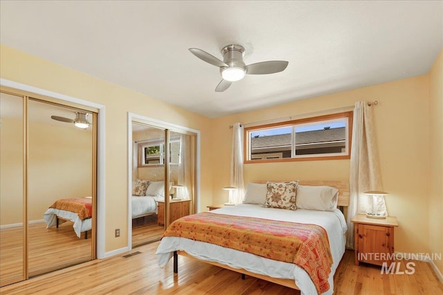 424 N Mobley Dr, Boise, ID 83712 - bedroom with light wood-style floors, two closets, baseboards, and a ceiling fan