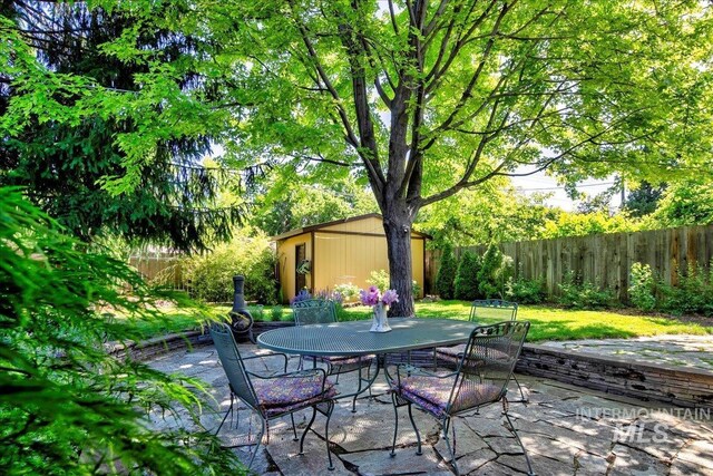 424 N Mobley Dr, Boise, ID 83712 - fenced backyard with an outbuilding, a patio, and outdoor dining space