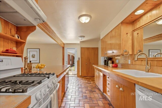 424 N Mobley Dr, Boise, ID 83712 - kitchen featuring white appliances, a sink, light countertops, brick flooring, and brown cabinets
