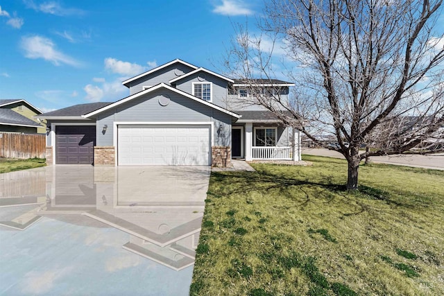 view of front of house with concrete driveway, a front yard, a garage, fence, and covered porch