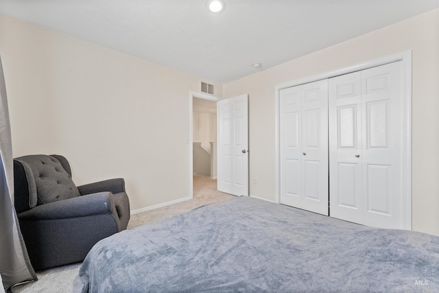 carpeted bedroom featuring a closet, baseboards, and visible vents