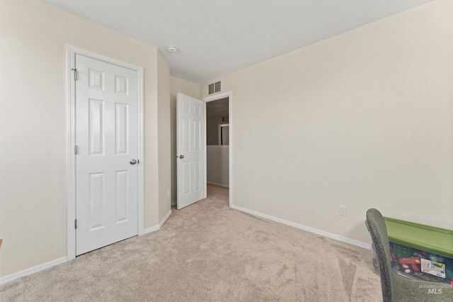 unfurnished bedroom with visible vents, baseboards, and carpet flooring