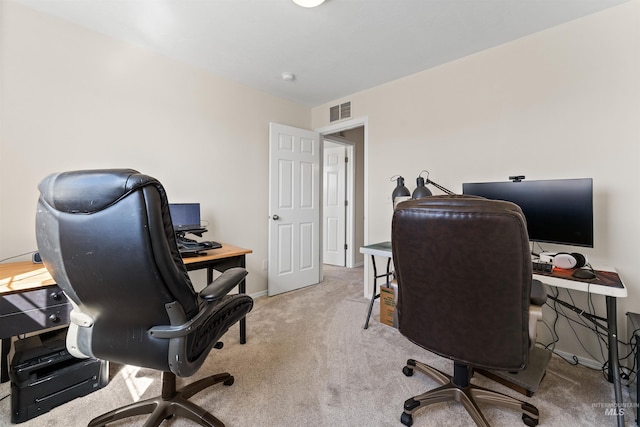 office area featuring baseboards, visible vents, and carpet floors