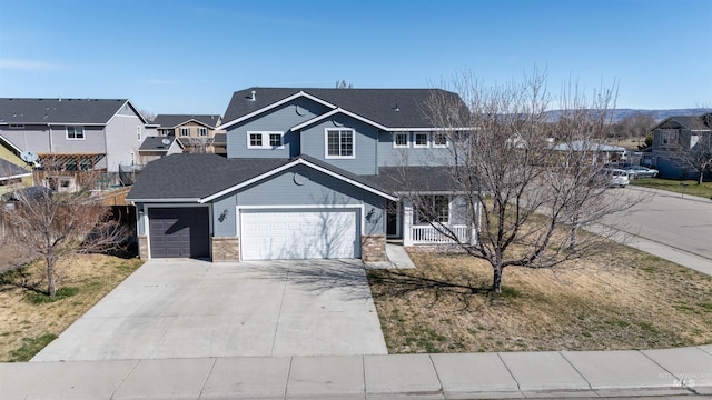 view of front of property with a porch, a garage, brick siding, a residential view, and driveway