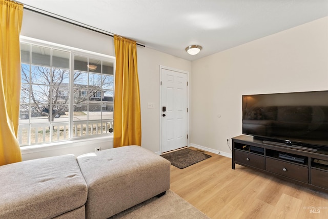 bedroom featuring light wood-style floors and baseboards