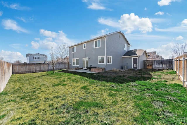 rear view of property featuring a yard, a patio area, and a fenced backyard