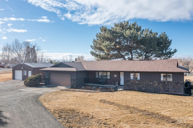 ranch-style home with a garage, concrete driveway, and a front yard