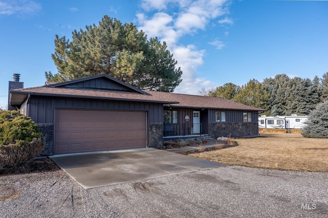 ranch-style house featuring a garage, concrete driveway, a chimney, board and batten siding, and a front yard