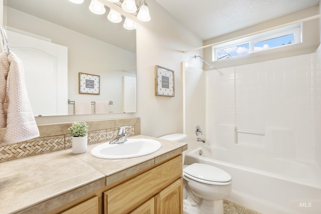 bathroom with vanity, washtub / shower combination, and toilet