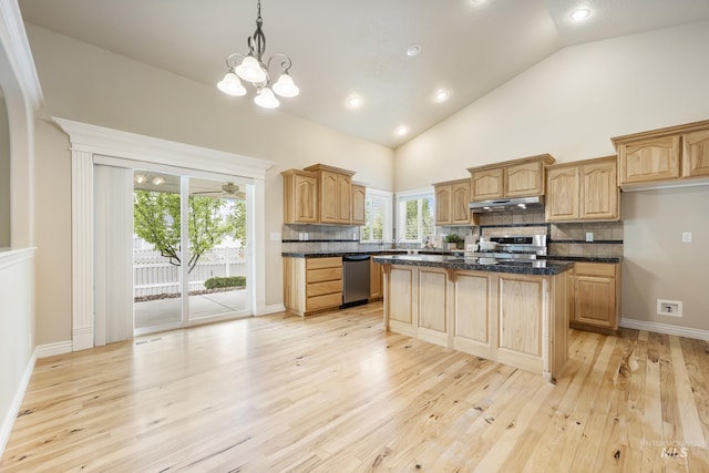 kitchen with a kitchen island, dishwasher, under cabinet range hood, tasteful backsplash, and range