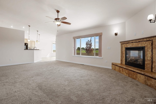 1041 Lupine Ln, Kimberly, ID 83341 - unfurnished living room with a tiled fireplace, ceiling fan, light colored carpet, and recessed lighting