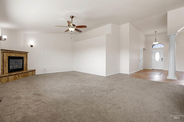 1041 Lupine Ln, Kimberly, ID 83341 - unfurnished living room featuring ceiling fan, light colored carpet, ornate columns, a fireplace, and vaulted ceiling