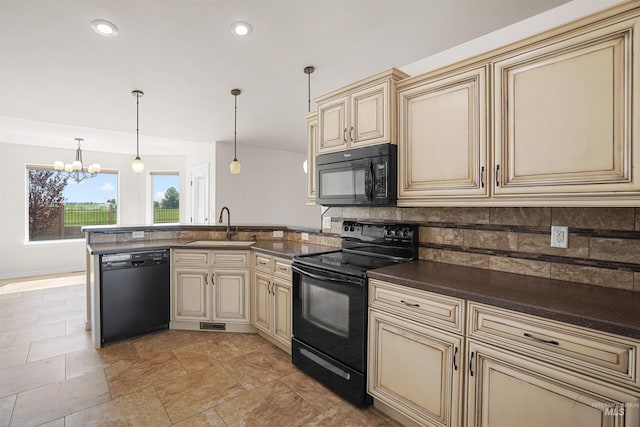 1041 Lupine Ln, Kimberly, ID 83341 - kitchen featuring cream cabinets, black appliances, a peninsula, a chandelier, and recessed lighting