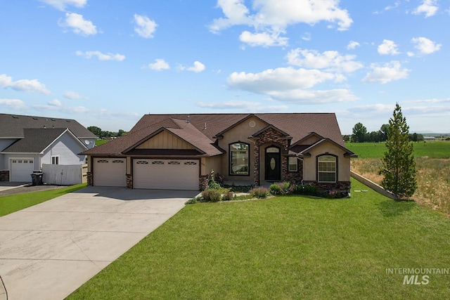 1041 Lupine Ln, Kimberly, ID 83341 - view of front of house featuring a garage, driveway, stone siding, a front yard, and stucco siding