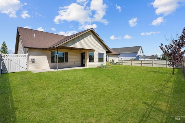 1041 Lupine Ln, Kimberly, ID 83341 - back of house with a patio, a fenced backyard, a shingled roof, and a gate