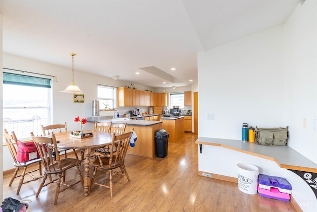 dining space with sink and light hardwood / wood-style floors