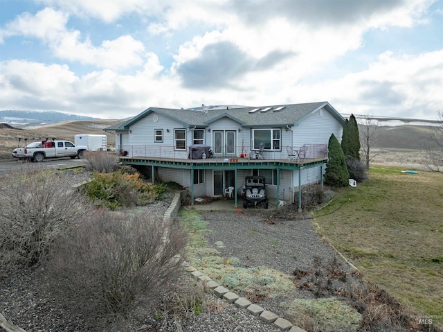 exterior space with a deck with mountain view