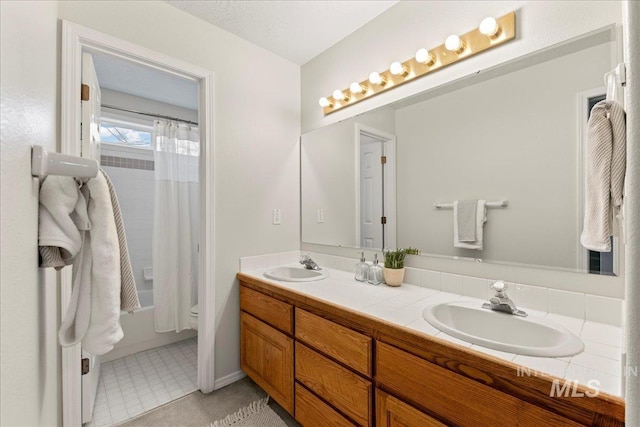 full bathroom with vanity, shower / tub combo with curtain, and toilet