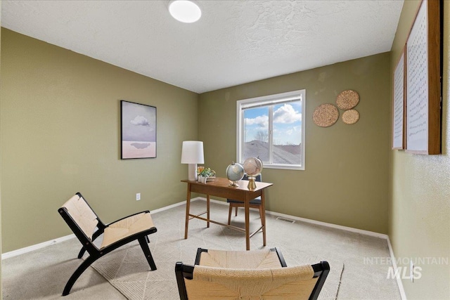 carpeted office with a textured ceiling