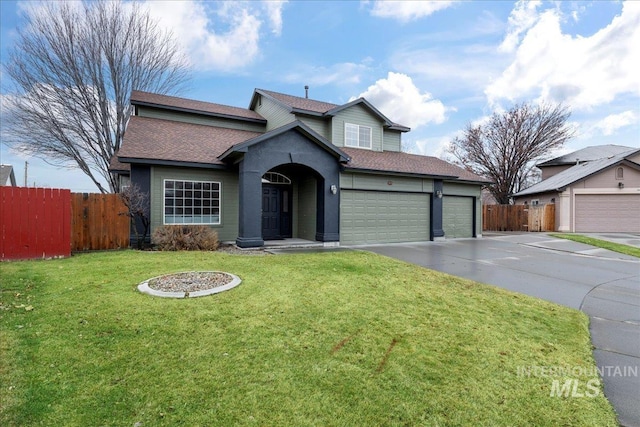 view of front of property with a garage and a front lawn