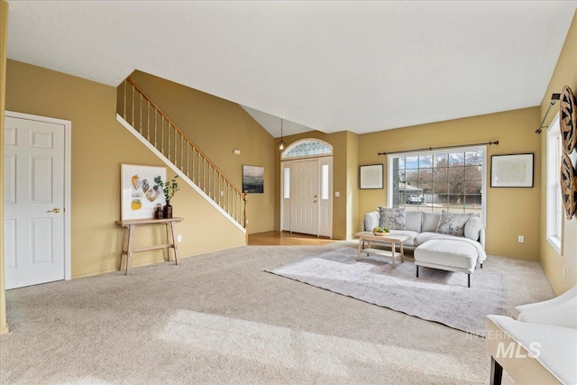 living room featuring light colored carpet and vaulted ceiling