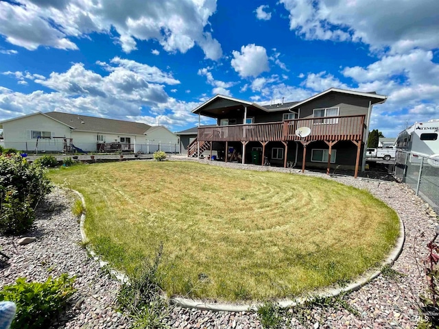 back of property featuring a lawn and a deck