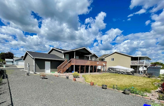 view of front of house with a garage, a front yard, and a deck