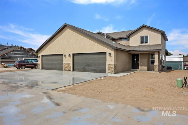 craftsman inspired home with a garage and central AC unit