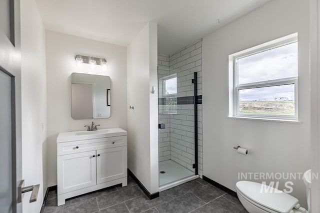 full bathroom featuring a shower stall, baseboards, toilet, tile patterned floors, and vanity