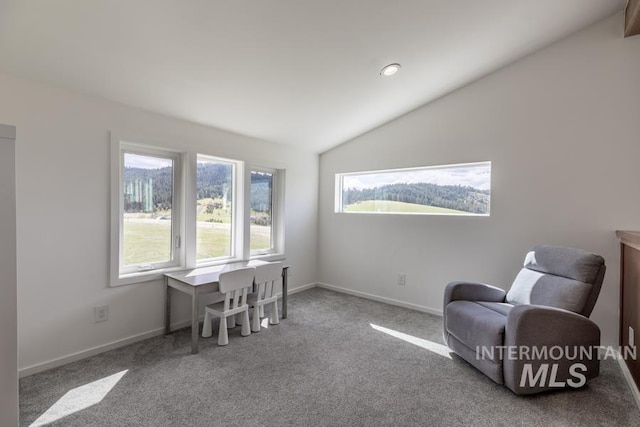sitting room featuring carpet flooring, baseboards, and lofted ceiling